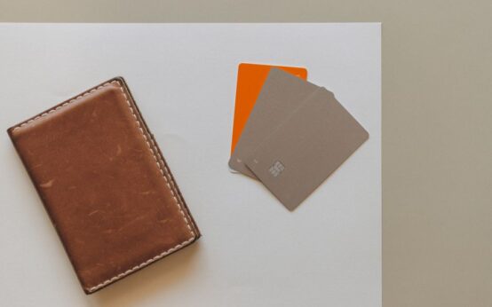 A leather wallet and credit cards on a minimalist background, ideal for financial themes.