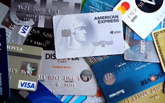 Close-up image of various credit and debit cards including Visa, MasterCard, American Express, and Discover.